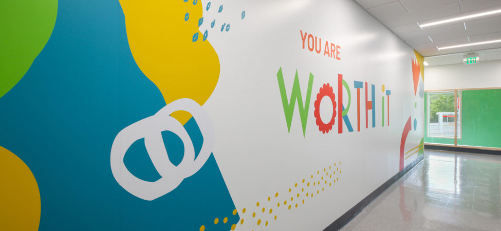 Colorful hallway with text that reads "you are worth it".