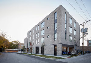 The rear exterior view of The 801 in Oak Park, IL, which includes on-site parking for residents