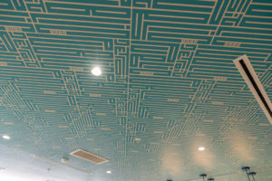 Detroit Public Theatre-branded wallpaper lines the ceiling of the bathroom at the nonprofit's Third Avenue Garage