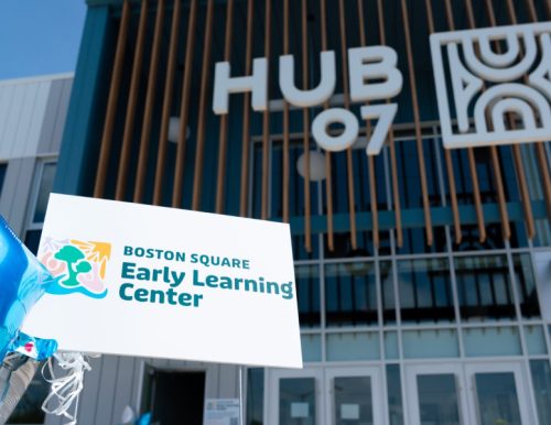 Sign for Boston Square Early Learning Center with building labeled HUB 07 in the background.