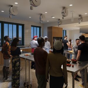 People gathered in a modern kitchen setting, engaging in a cooking class or social event with a chef instructing.