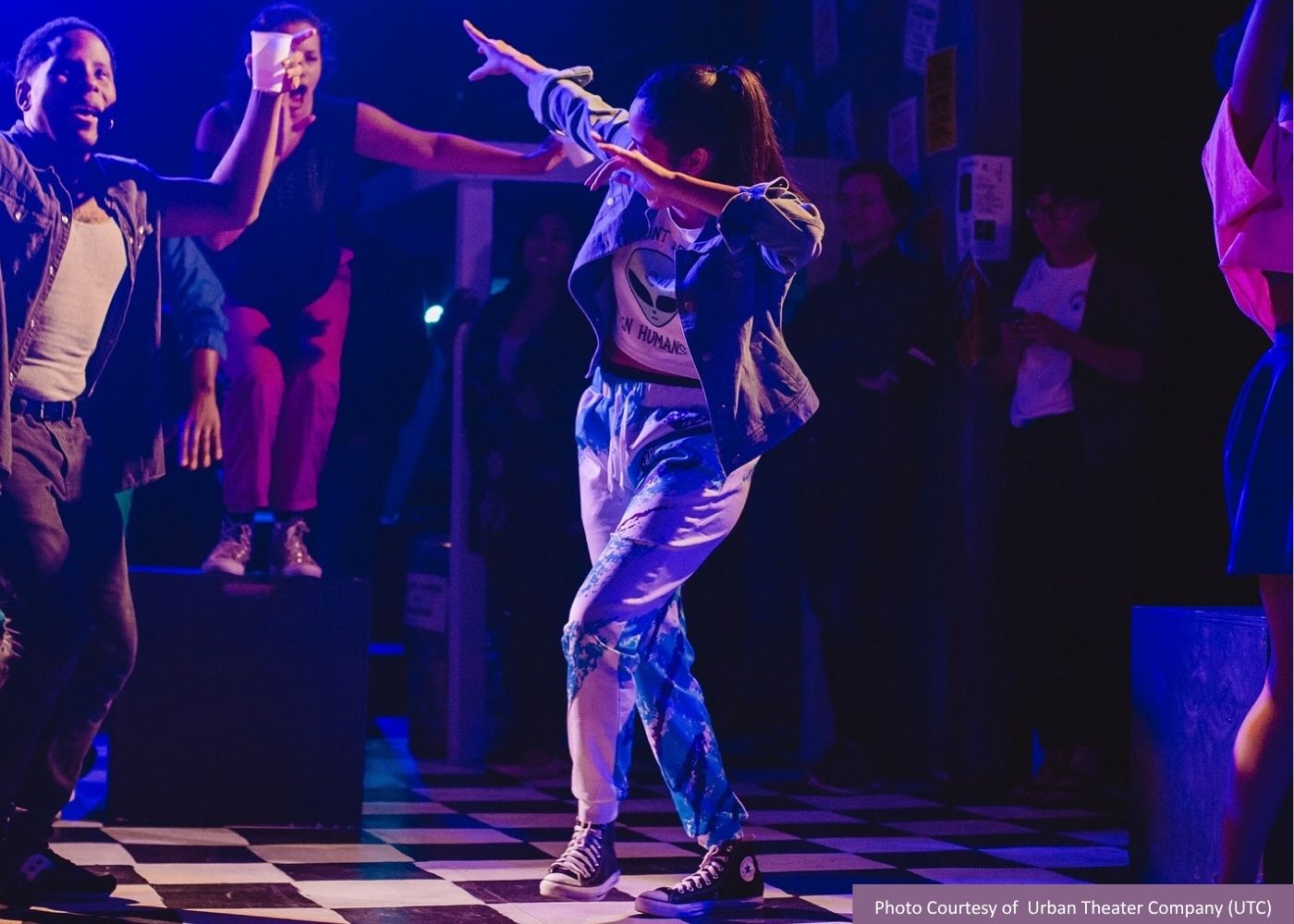 A woman performs a modern dance on a stage