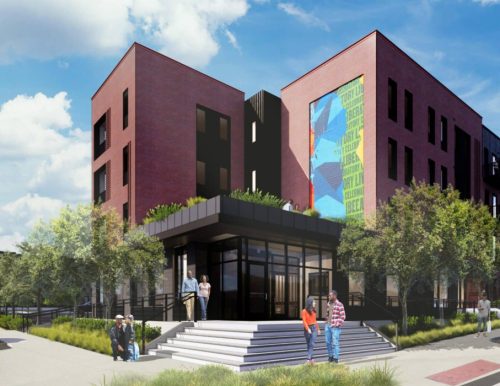 A rendering of a modern red brick building with a glass entrance and colorful mural is depicted, featuring people gathered at the steps and landscaped greenery surrounding the area.