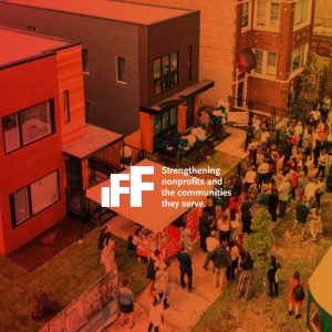 Aerial view of a lively community gathering outside a modern building with people mingling, food truck present, and festive decorations. IFF's logo is overlaid on the image.